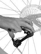 Hold the derailleur cage with your thumb